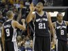 Spurs' Duncan celebrates with teammate Parker and Leonard during overtime in Game 3 of their NBA Western Conference final playoff basketball series in Memphis