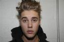 Handout shows Canadian pop singer Justin Bieber in police custody in Miami Beach, Florida