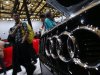People look at Audi cars during the 15th Shanghai International Automobile Industry Exhibition in Shanghai