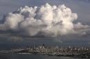 A large cloud gathers over the skyline of San Francisco