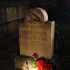 A flashlight shines on items left on the gravestone of Edgar Allen Poe by people who pretended to be the mysterious "Poe Toaster" in Baltimore, early Thursday, Jan. 19, 2012. Fans waited long past a midnight dreary to see if the true "Poe Toaster" would return after a two-year hiatus to leave cognac and roses upon the writer's grave on the anniversary of his birth, or whether the tradition had reached an end. The "Poe Toaster" was a no-show for a third year. (AP Photo/Patrick Semansky)