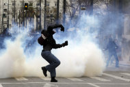 <p>               A protester throws a stone toward riot police during clashes in Athens, Friday, Feb. 10, 2012. Thousands took to the streets of Athens as unions launched a two-day general strike against planned austerity measures on Friday, a day after Greece's crucial international bailout was put in limbo by its partners in the 17-nation eurozone.  (AP Photo/Petros Giannakouris)