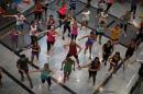 People take part in an aerobics class at a shopping centre in Malaga
