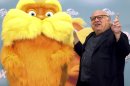 Actor Danny DeVito poses with the figure The Lorax to promote the premiere of the animated feature film 
