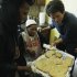 Detroit Free Press columnist Mitch Albom, right, helps Texana Hollis pull cookies from the oven in her home in Detroit, Wednesday, April 4, 2012. Hollis, a 101-year-old Detroit native was evicted from her foreclosed house Sept. 12 after her 65-year-old son failed to pay property taxes linked to a reverse mortgage and HUD foreclosed. Albom and his charity S.A.Y. Detroit helped to renovate Hollis' house. (AP Photo/Carlos Osorio)