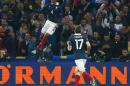 France's defender and Captain Raphael Varane, jumps after scoring against Sweden, during an international friendly soccer match between France and Sweden, at the Velodrome Stadium, in Marseille, southern France, Tuesday, Nov. 18, 2014. (AP Photo/Claude Paris)