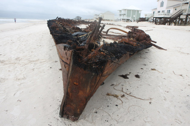 In this Wednesday, Sept. 5, 2012 photo, the ghostly remains of an old wooden ship rest along a private beach at Fort Morgan, Ala. The ship is the Rachel, a schooner built in Pascagoula, Miss., during World War I, according to Mike Bailey, historian with the Fort Morgan Historical Society. The ship was lost in a storm in 1923. The remains of the the Rachel have been uncovered by hurricanes in the past, but more of the wreck was revealed in the wake of Hurricane Isaac. (AP Photo/Press-Register, Brian Kelly) MAGS OUT