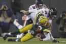 Green Bay Packers quarterback Aaron Rodgers is sacked by Chicago Bears' Shea McClellin (99) and Isaiah Frey (31) during the first half of an NFL football game Monday, Nov. 4, 2013, in Green Bay, Wis. Rodgers left the game after the play. (AP Photo/Jeffrey Phelps)
