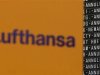 The Logo of German air carrier Lufthansa is pictured next to a departure board during a five-hour warning strike, following a pay dispute, represented by German united services union Ver.di at the Fraport airport in Frankfurt