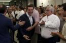Greek former Prime Minister Tsipras is welcomed by members of his Syriza party during a meeting in Athens