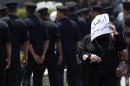 A woman walks during a funeral for soldiers in Cairo