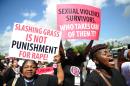 Protestors march towards police headquarters on October 31, 2013 in Nairobi to deliver a petition of over a million names demanding justice after men accused of brutally gang raping a schoolgirl cut grass as punishment