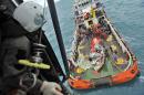 In this photo taken from an Indonesian Air Force Super Puma helicopter Saturday, Jan. 10, 2015, portion of the tail of AirAsia Flight 8501 is seen on the deck of a rescue ship after it was recovered from the sea floor on the Java Sea. Investigators searching for the crashed AirAsia plane's black boxes lifted the tail portion of the jet out of the Java Sea on Saturday, two weeks after it went down, killing all 162 people on board. (AP Photo/Prasetyo Utomo, Pool)