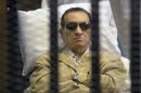 FILE - In this Saturday, June 2, 2012 file photo, Egypt's ex-President Hosni Mubarak lays on a gurney inside a barred cage in the police academy courthouse in Cairo, Egypt. An Egyptian prison official says Hosni Mubarak's health has taken a turn to the worst and is likely to be moved out of his prison hospital to a military facility nearby. The official said Tuesday doctors reported that the 84-year old former president has fallen unconscious. He said they have used a defibrillator to restart his heart, and have been administering breathing aid. (AP Photo, File)