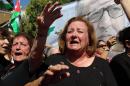 Mourners chant slogans and wave the national flag during the funeral of Jordanian writer Nahed Hattar, who was shot dead earlier this week outside an Amman court, in the town of Fuheis, 20km northwest of the capital Amman on September 28, 2016