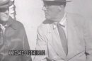 This image from an eight-second film clip provided by the National Archives shows President Franklin Delano Roosevelt, right, aboard the U.S.S. Baltimore in Pearl Harbor in July 1944, depicting a secret not revealed to the public until after his death. Person at left is unidentified. (AP Photo/National Archives)
