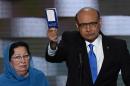 Khizr Khan, pictured brandishing his copy of the US Constitution on July 28, 2016, has gone head to head with the insult-dishing Donald Trump in a confrontation that has dominated the US news cycle for days