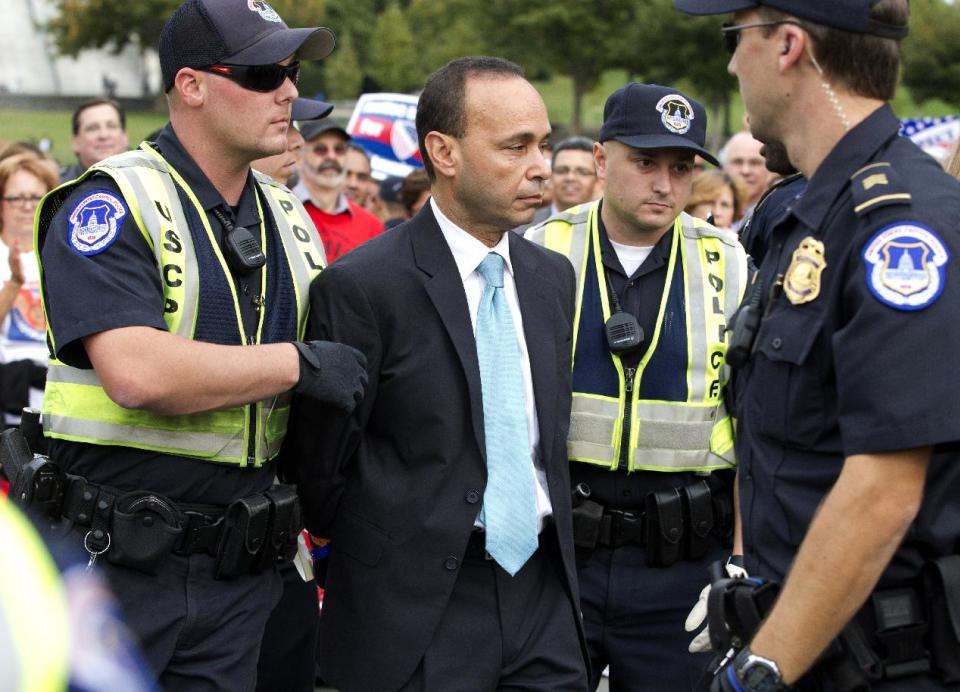 Rep. Luis Gutierrez, D-Ill., is arrested by U.S. Capitol Police officers on Capitol Hill during a immigration rally in Washington, on Tuesday, Oct. 8, 2013. ( AP Photo/Jose Luis Magana)