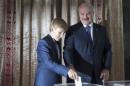 Belarus' President Lukashenko, accompanied with his son Nikolay, casts his ballot during a presidential election at a polling station in Minsk