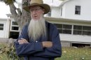 FILE-This is an Oct. 10, 2011 file photo of Amish leader Sam Mullet standing in front of his home in Bergholz, Ohio. A judge has rejected a challenge of the federal hate crimes law by Amish defendants charged in beard-cutting attacks on fellow Amish in Ohio. (AP Photo/Amy Sancetta, File)