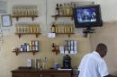 A worker tends bar in Havana, Cuba, Saturday, April 11, 2015, next to a television tuned into the live telecast of President Barack Obama's speech at the VII Summit of the Americas. Cuba dedicated a special TV channel to live coverage of the Summit of the Americas, but relatively few in Havana seemed to have watched when President Raul Castro made his impassioned speech. Many capital residents said they had no idea it was going to be on. (AP Photo/Desmond Boylan)