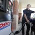 FILE - Nov. 8, 2011 file photo, Yuri Godin, of Charlotte, N.C., pumps gas at a Costco in Matthews, N.C. Costco Wholesale Corp. said Thursday, Feb. 2, 2012, that revenue at stores open at least a year climbed 8 percent in January, helped by higher gas prices. (AP Photo/Chuck Burton, File)