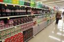 A shopper walks by the sodas aisle at a grocery store in Los Angeles