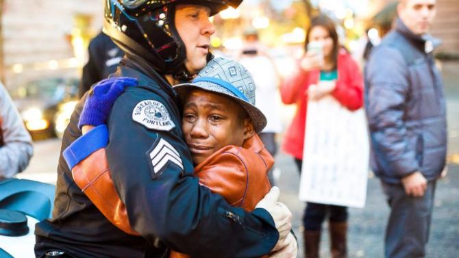 Photo of Cop Hugging Boy at Ferguson Protest Tells Poignant Story