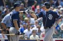 San Diego Padres' Nick Hundley, left, high-fives teammate Chase Headley after Headley hit a solo home run during the fourth inning of a baseball game against the Chicago Cubs, Monday, May 28, 2012 in Chicago. (AP Photo/Brian Kersey)