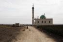 A mosque which used to be a base for Al-Qaeda loyalists of the Islamic State of Iraq and the Levant (ISIL) in seen on the outskirts of the Syrian Kurdish town of Ras al-Ain, next to the Turkish border, on November 21, 2013