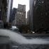 Water gushes from a hose as it is pumped out of a basement in New York's financial district, Wednesday, Oct. 31, 2012. Much of lower Manhattan and the financial district are still without electrical power. The Federal Reserve Bank of New York is background center. (AP Photo/Mark Lennihan)
