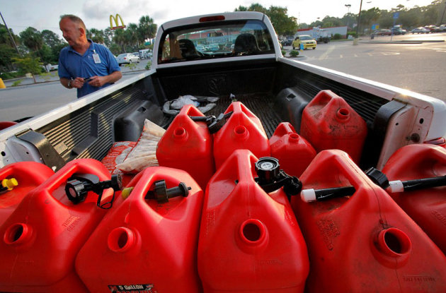 Resort landscaping manager Chris Jaeger fills his truck and ten five-gallon gas containers Tuesday morning in Garden City, S.C., Tuesday Aug. 23, 2011. Jaeger said they gassed up their vehicles Monday and just want to be prepared in case Hurricane Irene hits the Myrtle Beach, S.C. area. (AP Photo/The Sun News , Steve Jessmore)