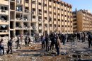 In this photo released by the Syrian official news agency SANA, Syrian people gather at the site after an explosion hit a university in Aleppo, Syria, Tuesday, Jan. 15, 2013. Two explosions struck the main university in the northern Syrian city of Aleppo on Tuesday, causing an unknown number of casualties, state media and anti-government activists said. There were conflicting reports as to what caused the blast at Aleppo University, which was in session Tuesday. (AP Photo/SANA)
