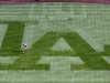 A Los Angeles Dodgers grounds crewman sweeps away dew from centerfield grass to prepare field to play against San Francisco Giants in the opening game of MLB National League baseball season in Los Angeles
