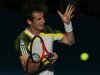 Murray of Britain hits a return to Istomin of Uzbekistan during their men's singles match at the Brisbane International tennis tournament