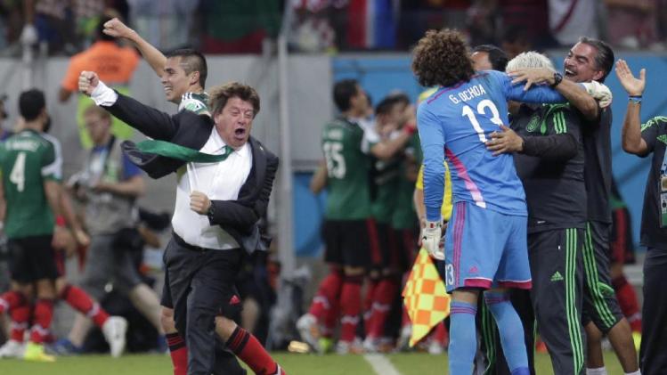 Mexico&#39;s head coach Miguel Herrera celebrates after Mexico&#39;s Andres Guardado  scored his side&#39;s second goal during the group A World Cup soccer match between Croatia and Mexico at the Arena Pernambuco in Recife, Brazil, Monday, June 23, 2014