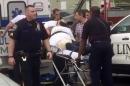 Policemen place in an ambulance a man they identified as Ahmad Khan Rahami in Linden