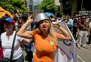 An opposition member wearing a pot on her head shouts &hellip;