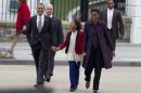 President Barack Obama, first lady Michelle Obama, and daughter Sasha hold hands as they walk from the White House through Lafayette Park to attend services at St. John's Church Sunday, March 18, 2012, in Washington. (AP Photo/Carolyn Kaster)
