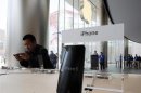 A visitor tries out an iPhone at an Apple store in Beijing