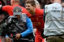 Liverpool's English midfielder Steven Gerrard (C) celebrates at the final whistle during the English Premier League football match between Liverpool and Manchester City at Anfield in Liverpool on April 13, 2014