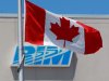 FILE- In this  June 29, 2012, photo, the Canadian Flag flies in front of the Research In Motion (RIM) company logo on one of their many buildings,in Waterloo, Canada. Shareholders of Research In Motion, perhaps some of the most staunch supporters of the BlackBerry smartphone, are expected to take a far more critical view of the embattled company at its annual meeting on Tuesday. (AP Photo/The Canadian Press, Dave Chidley)