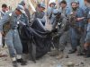 Afghan police officers carry the body of a hotel guard in a black cloth after a suicide attack in Kunduz, north of Kabul, Afghanistan, Tuesday, Aug. 2, 2011. A suicide car bomber blew up his vehicle outside a small residential hotel frequented by foreigners just after dawn Tuesday. (AP Photo/ Ahmed Bilal)