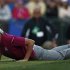 Team Europe golfer Poulter lays on the ground to line up a putt on the 18th green during the afternoon four-ball round at the 39th Ryder Cup golf matches at the Medinah Country Club