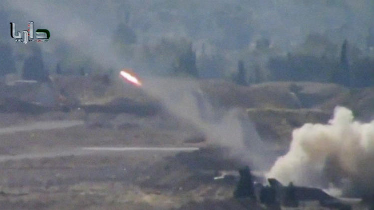 In this image taken from video obtained from the Shaam News Network, which has been authenticated based on its contents and other AP reporting, a rocket soars through the air in Daraya on the outskirts of Damascus, Syria, Tuesday, Nov. 5, 2013. (AP Photo/Shaam News Network via AP Video)