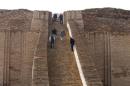 People stand on the steps of the Ziggurat of Ur ruins near Nassiriya southeast of Baghdad