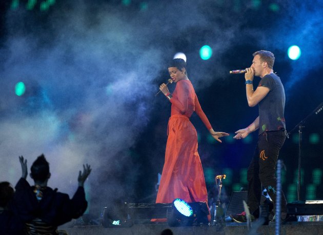 Singer Rihanna performs with Chris Martin lead vocals of the British rock band Coldplay during the closing ceremony for the 2012 Paralympics games, Sunday, Sept. 9, 2012, in London. (AP Photo/Matt Dunham)