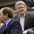 Canadian Prime Minister Stephen Harper sits with NHL Commissioner Gary Bettman during the NHL All-Star hockey game in Ottawa