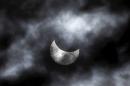 The moon starts to block the sun during a solar eclipse seen through clouds, in Skopje, Macedonia, Friday, March 20, 2015. An eclipse, a rare solar event, is darkening parts of Europe on Friday in the last total solar eclipse in Europe for over a decade (AP Photo/Boris Grdanoski)