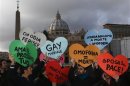 Members of a gay activist group hold signs in front of St. Peter's square in the Vatican